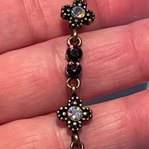 Lovely 8” nickel colored bracelet.  Clear shiny stones & red colored stones.